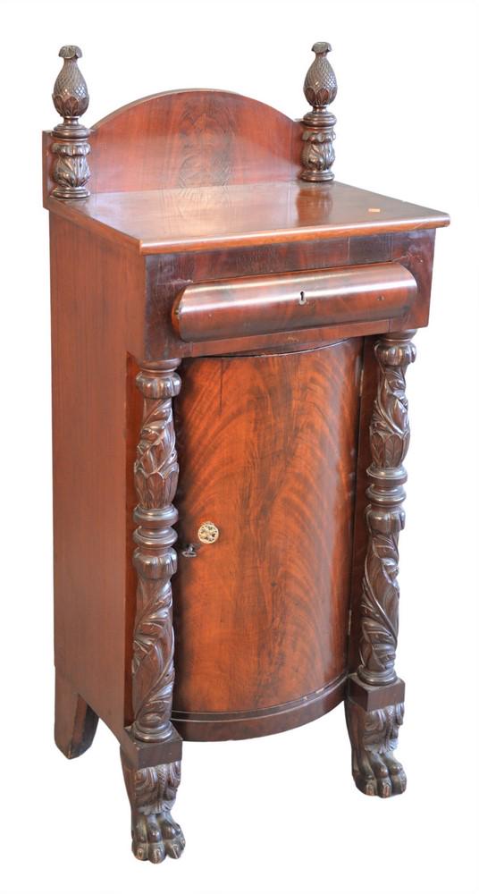 Empire Style Mahogany Cabinet, having one drawer over: Empire Style Mahogany Cabinet, having one drawer over one door, flanked by heavily carved pillars ending in paw feet, height 49 inches, width 21 inches.