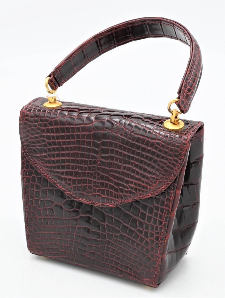 Giorgio's of Palm Beach Handbag, burgundy alligator: Giorgio's of Palm Beach Handbag, burgundy alligator clutch purse, new with tags, $2,950., having shoulder strap inside, height 5 inches, width 5 inches, depth. 2 3/4 inches.