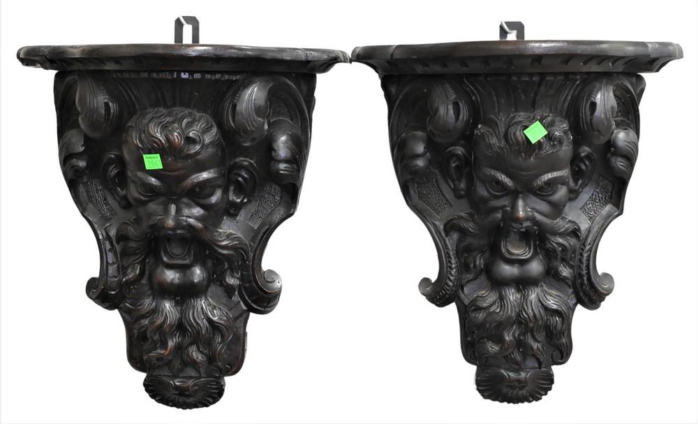 Pair of Carved Wall Shelves, carved with a mask of a man, height 17 inches, width 14 3/4 inches,: Pair of Carved Wall Shelves, carved with a mask of a man, height 17 inches, width 14 3/4 inches, depth 7 1/2 inches.
