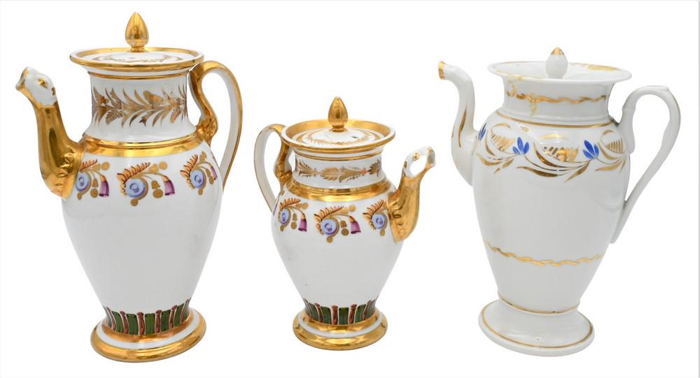 Three French Porcelain Pots, to include two having gilt decoration and animal spouts, one: Three French Porcelain Pots, to include two having gilt decoration and animal spouts, one unmatching, one cover with hairline, one small chip inside cover, heights 9 and 11 1/4 inches.