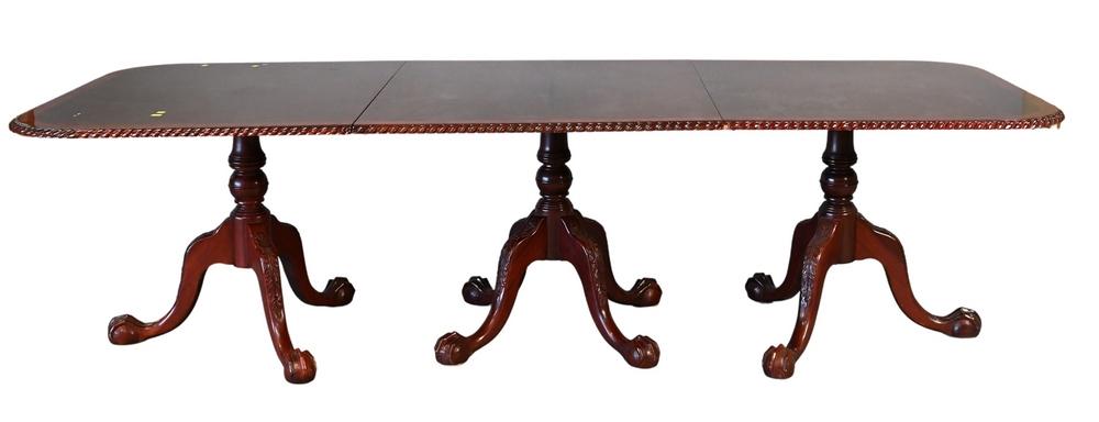 Reproduction Mahogany Triple Pedestal Dining Table, having rope edge top over carved pedestals with: Reproduction Mahogany Triple Pedestal Dining Table, having rope edge top over carved pedestals with ball and claw feet, having two 20 inch leaves, late 20th century, (one small chip on edge), height 3