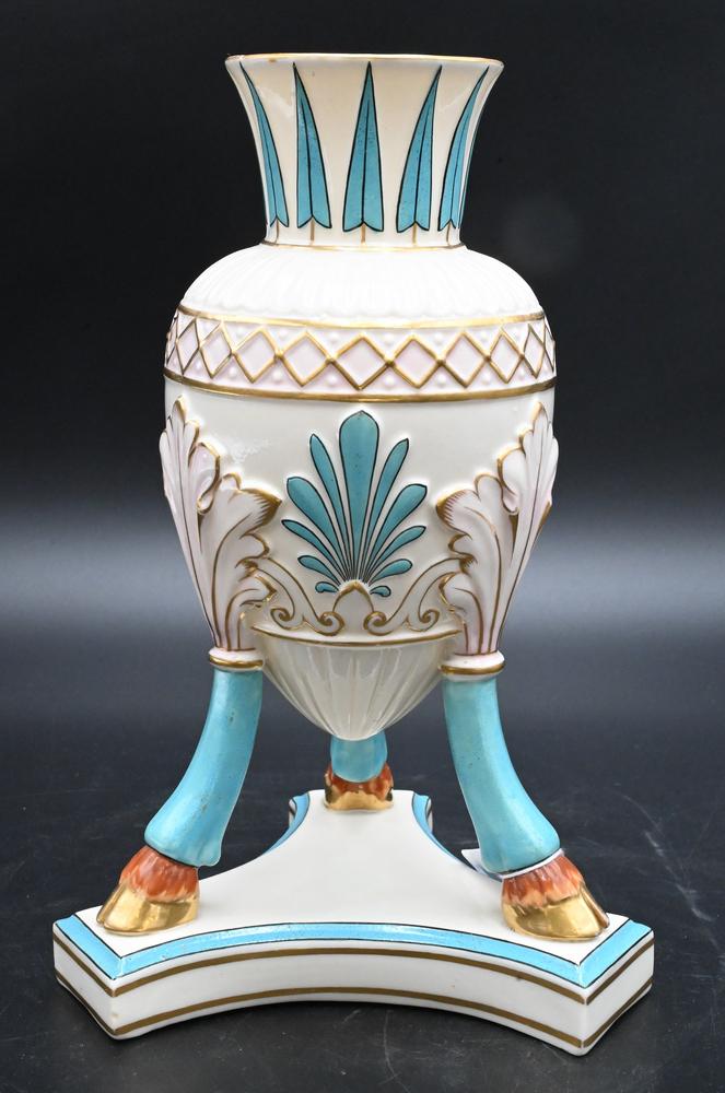 Belleek Amphora Vase or Urn, on tripod floof foot legs and platform base, early black mark on: Belleek Amphora Vase or Urn, on tripod floof foot legs and platform base, early black mark on bottom, height 10 inches. Provenance: Collections of Norma Reilly, New Jersey.