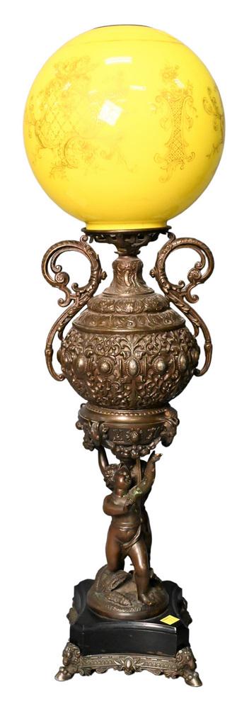 Figural Piano Lamp, having two putti figures holding oil well, yellow glass shade, height 28 inches. (1 of 4)