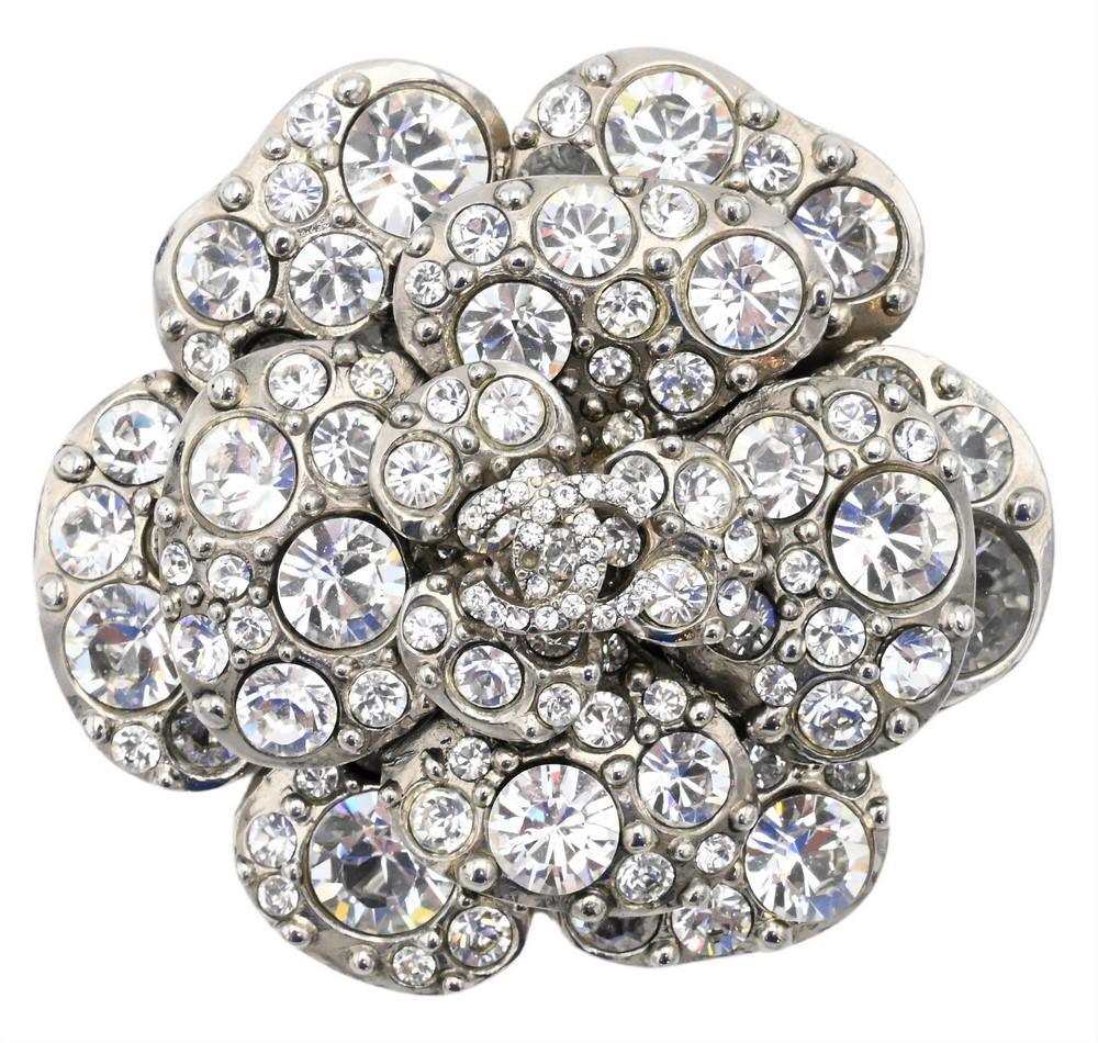 Chanel Brooch, designed as a flower with glass diamond pedals and central signature Chanel mark,: Chanel Brooch, designed as a flower with glass diamond pedals and central signature Chanel mark, diameter 2 1/4 inches.