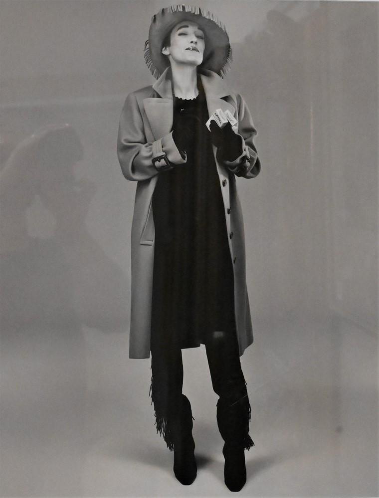 Michel Comte (Swiss, born 1954), black and white photograph of a woman smoking, having label on: Michel Comte (Swiss, born 1954), black and white photograph of a woman smoking, having label on verso reading International Festival of Fashion Photography, 19" x 14 3/4".