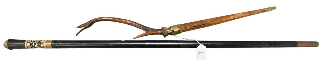 Two Swords: Two Swords, to include an Austrian antler handle sword having leather scabbard and brass fittings, length 24 inches; along with a carved sword cane, inlaid handle with brass lion head cap, length 36 i