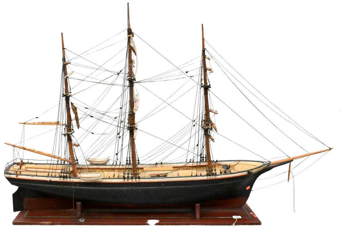 Large Wooden Model of a Clipper Ship: Large Wooden Model of a Clipper Ship, having three masts, painted red and black, on matching stand, height 42 inches, length 65 inches. Provenance: Estate of Peter Tillou, Litchfield, Connecticut.
