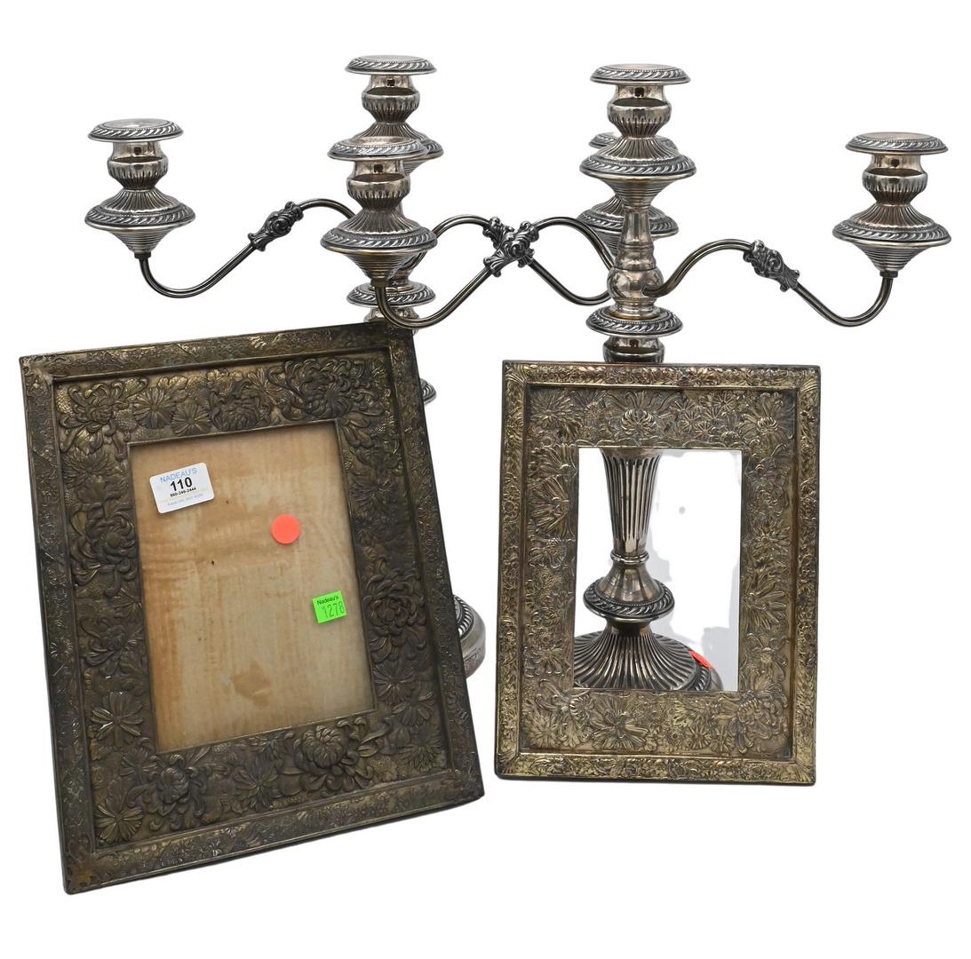 Silver Plated Group: Silver Plated Group, to include two Chrysanthemum picture frames, along with a pair of candelabras; one frame size 10 1/2" x 13", picture size 5 1/2" x 2 3/4", second frame size 8 1/4" x 11", second p