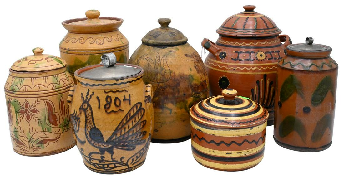 Seven Greg Shooner Redware Pottery Covered Jars: Seven Greg Shooner Redware Pottery Covered Jars, painted in Early American manner, all signed on the bottoms, tallest 10 inches. Provenance: Estate of Peter Tillou, Litchfield, Connecticut.