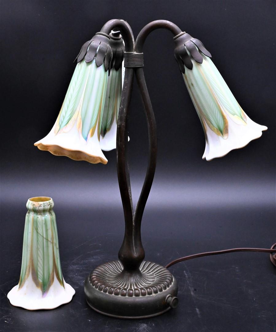 Tiffany Studios Bronze Three Light Lily Desk Lamp: Tiffany Studios Bronze Three Light Lily Desk Lamp, heavy three pull feature, Quezal art glass shades, marked Tiffany Studios New York 319 on bottom, height 13 inches.
