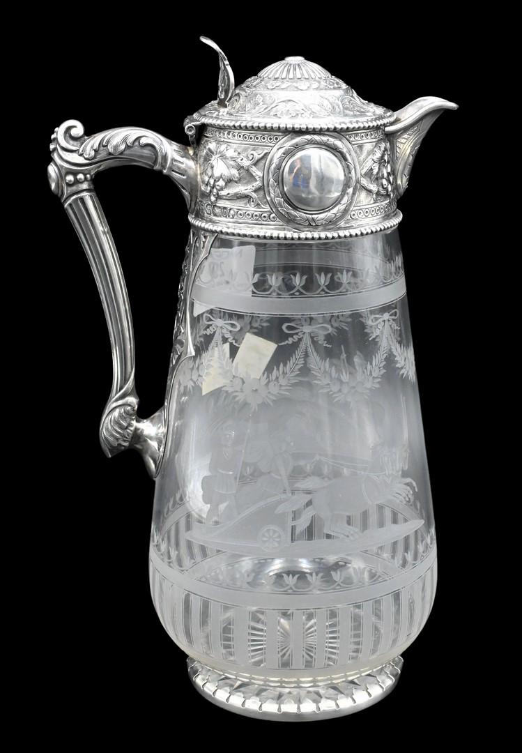 Continental Silver and Glass Pitcher: Continental Silver and Glass Pitcher, having etched chariot scene on glass with silver top and handle, touch marks on side, height 10 inches.
