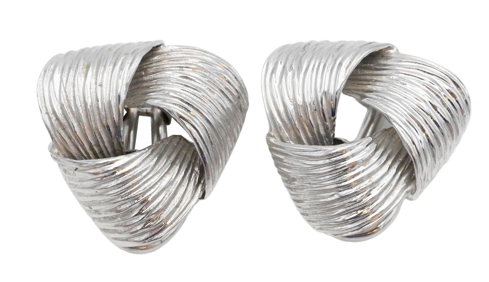A Pair of 18 Karat White Gold Ear Clips: A Pair of 18 Karat White Gold Ear Clips, length 1 3/4 inches, 8.8 grams.**PLEASE NOTE** For first time buyerâ€™s with our auction gallery, we do not accept credit cards or checks for jewelry, gol