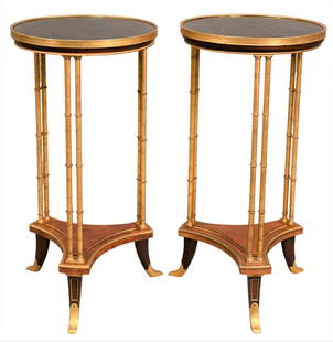 A Pair of Louis XVI Style Bronze Ormolu and Burl Maple Gueridon A Doubles Colonnettes Tables: A Pair of Louis XVI Style Bronze Ormolu and Burl Maple Gueridon A Doubles Colonnettes Tables in the manner of Adam Weisweiler each having black granite top above double-engaged column supports and tri