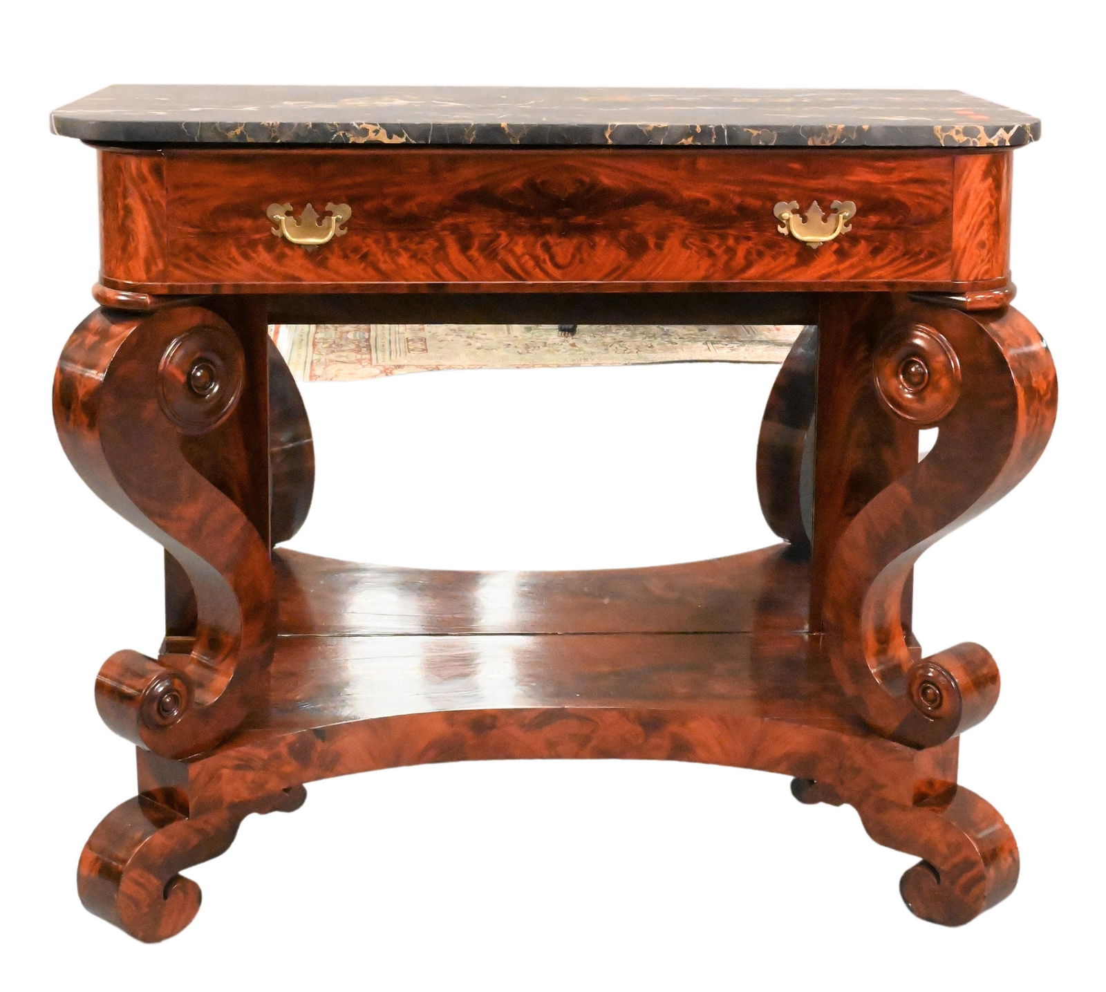 Classical Mahogany and Flamed Mahogany Pier Table: Classical Mahogany and Flamed Mahogany Pier Table Philadelphia or Boston, having Egyptian black marble top over one drawer on scroll supports with mirrored back height 38 1/2 inches, top 20 1/2" x 45"