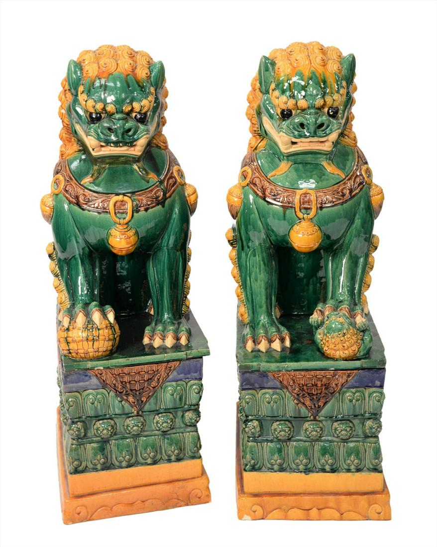 Massive Pair of Chinese Buddhists Lions: Massive Pair of Chinese Buddhists Lions, on matching rectangular stands with lion masks, all with green, gold, brown, and blue glazing, small minor chips, height 50 inches, width 16 inches, depth 23 i
