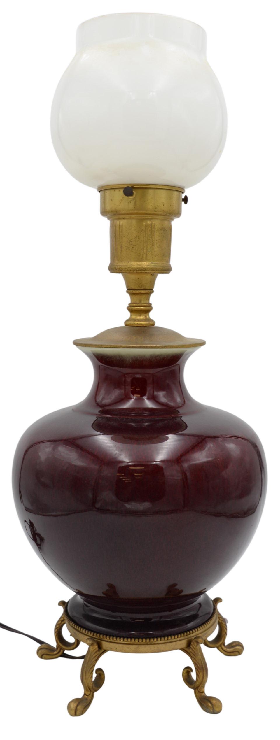 Chinese Sang de Boeuf Porcelain Vase: Chinese Sang de Boeuf Porcelain Vase, having globular form with oxblood body tapering into white flared rim, made into a table lamp, height 14 1/2 inches.