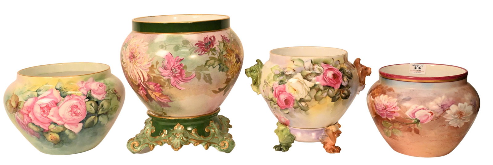 Four Limoges Hand Painted Floral Motif Jardiniers: Four Limoges Hand Painted Floral Motif Jardiniers, two with stands and lion head handles, largest height 9 1/2 inches.