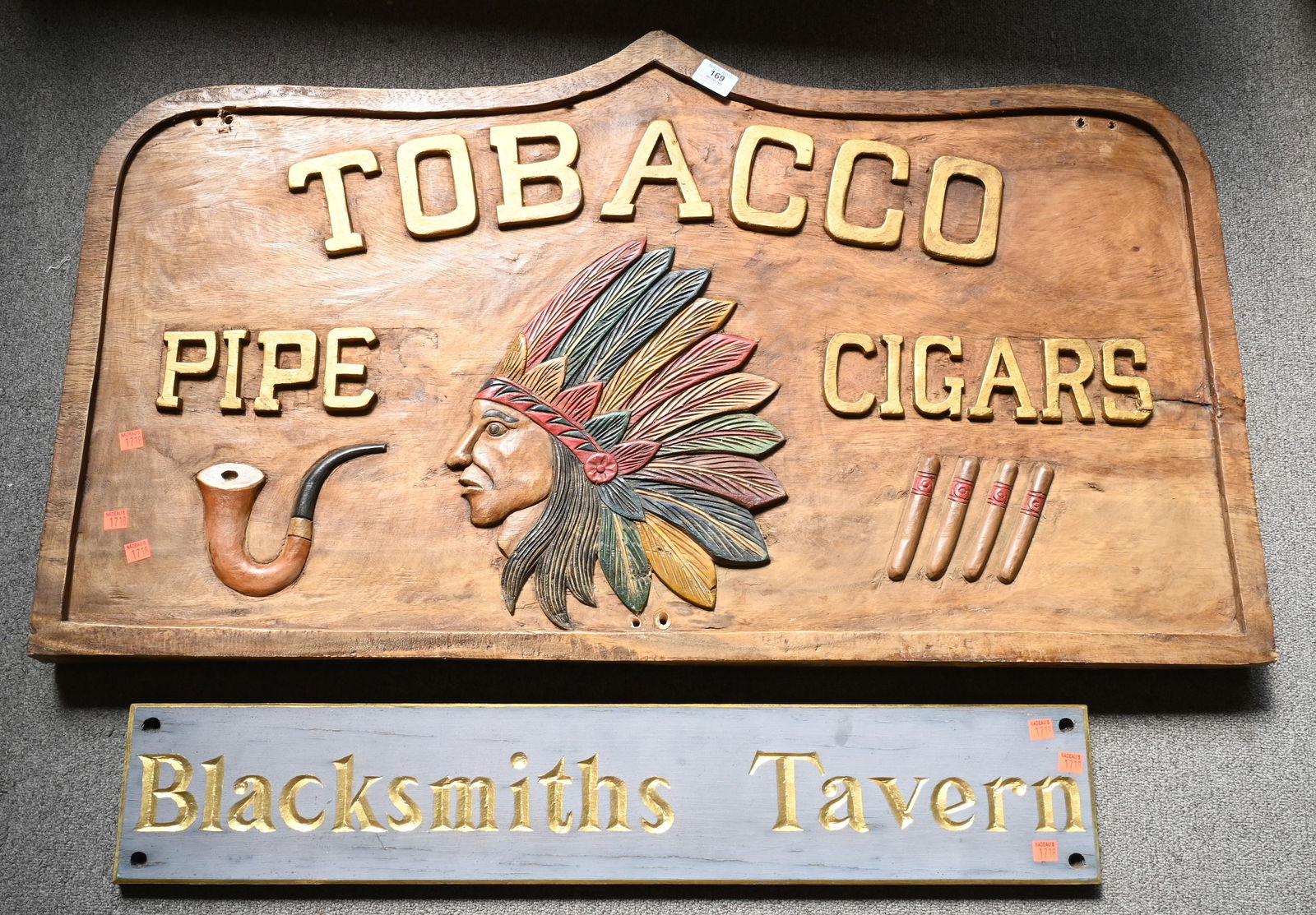 Three Carved Wood and Paint Decorated Signs: Three Carved Wood and Paint Decorated Signs, to include Blacksmith's Tavern, length 33 inches, Tobacco Pipe Cigars, with Indian in headdress, length 42 inches, along with Megson & Heagle Civil Enginee