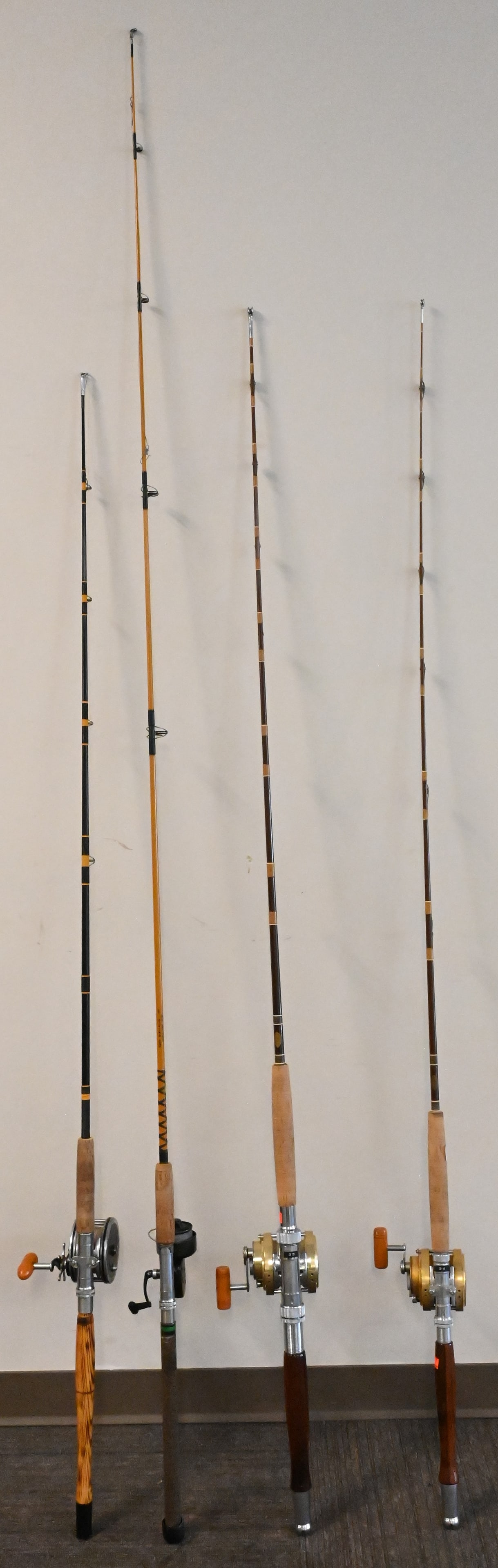 Four Saltwater Rods with Reels: Four Saltwater Rods with Reels, #30 Penn International, #20 Penn International, Penn Master Mariner, plus a spinning reel.
