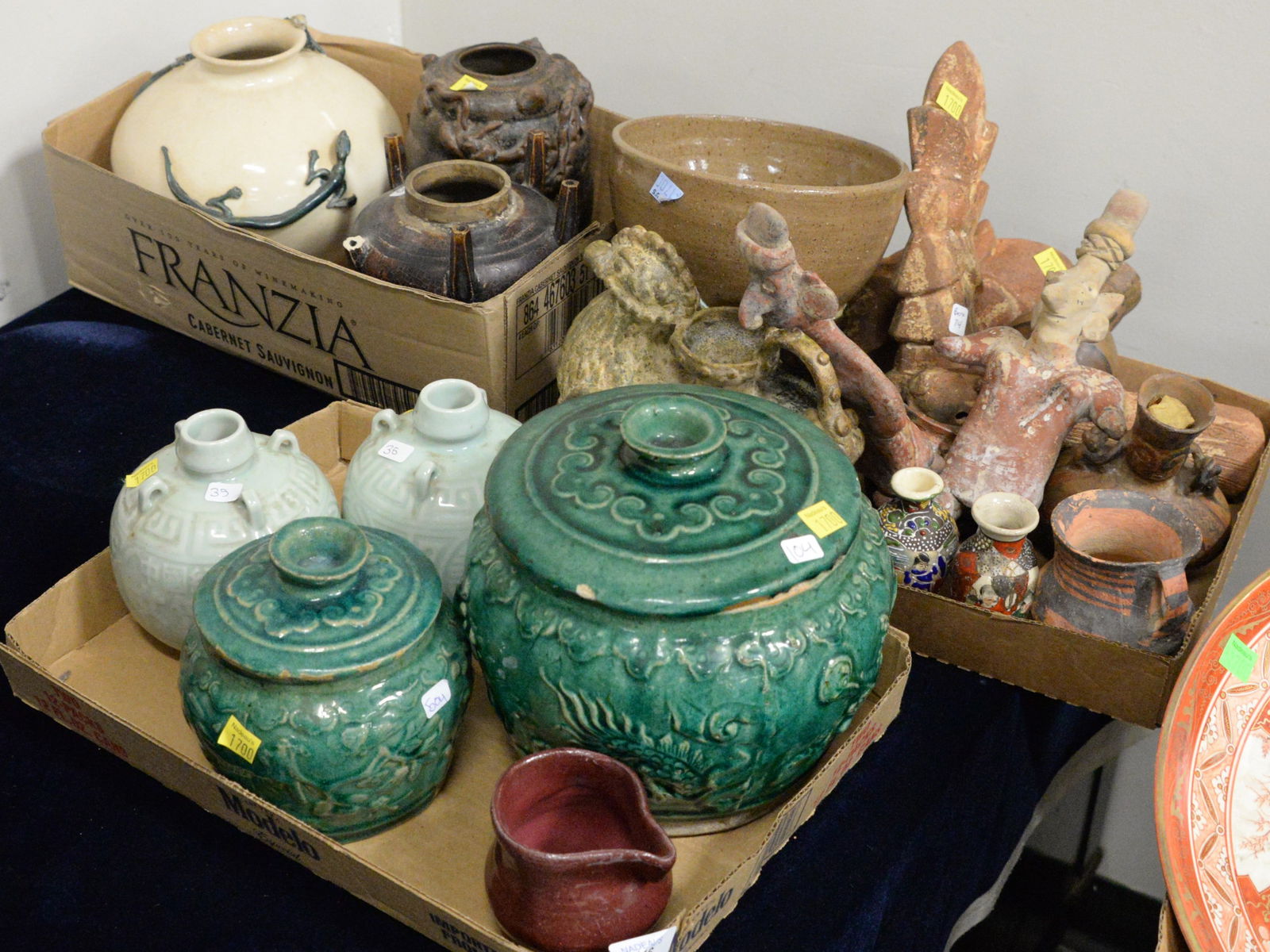 Three Tray Lots of Chinese Pottery: Three Tray Lots of Chinese Pottery, to include two green glazed earthenware ginger jars with lids, two celadon rice wine pouring jugs, clay figures, ceramic bird vessel, etc., largest piece 7 inches h