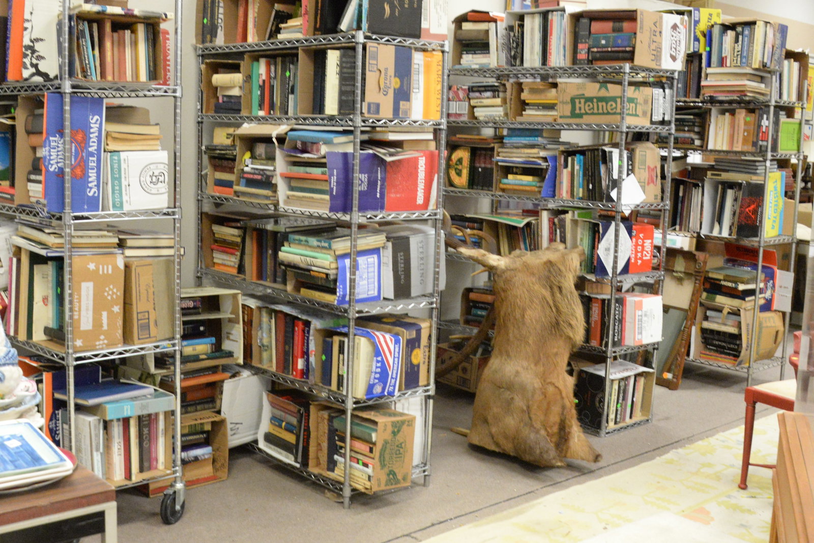 Four racks of books: Four racks of books, to include mostly hardcover, some coffee table books, etc.