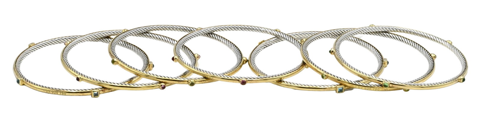 David Yurman Set of Seven 18K Yellow Gold and Sterling Silver Stacking Bracelets: David Yurman Set of Seven 18K Yellow Gold and Sterling Silver Stacking Bracelets each mounted with various colored stones, with original pouches outer diameter approximately 9 inches, inner diameter a