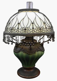 Tiffany Studios Moorish Oil Lamp: Tiffany Studios Moorish Oil Lamp greenish iridescent glass with "watermelon stripe", body having bronze mounts with white/yellow opaque glass shade and bronze filigree over dangling ball fringe, marke