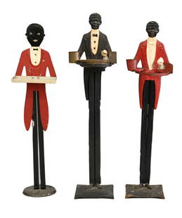 Three Vintage Cast Iron Black Americana Butler Smoking Stands to include: Three Vintage Cast Iron Black Americana Butler Smoking Stands to include One having brass ashtray and cup for matches, on square base, height 35 1/2 inches One having metal ashtray and red suit on rou