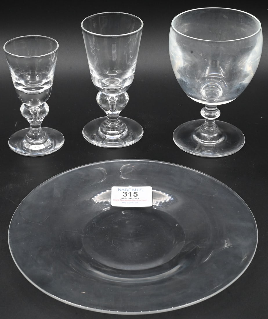 53 Piece Steuben Crystal Lot: 53 Piece Steuben Crystal Lot to include 12 plates, nine white wine stems, 12 cordial stems in fitted box, 10 miscellaneous stems, along with plates Provenance: Gentlemen's Estate Watch Hill, Rhode Isl