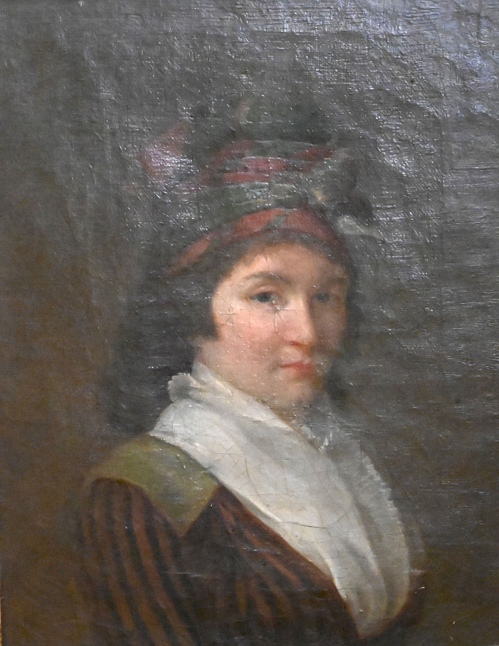 Continental School (18th Century or Later): Continental School (18th Century or Later) Portrait of a woman with a red and green head wrap and striped dress Oil on canvas Monogram on verso along with red wax seal 11 1/2" x 8 1/2"