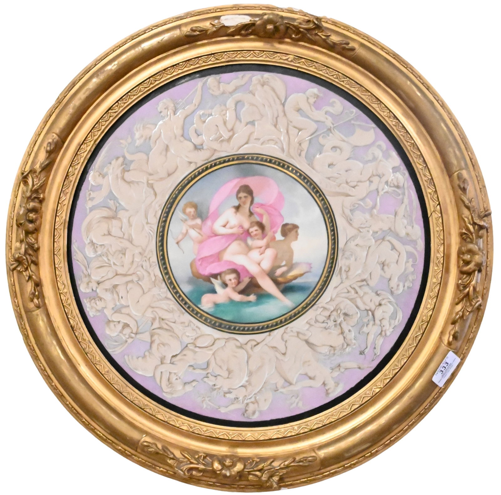 Birth of Venus Large Portrait Plaque: Birth of Venus Large Portrait Plaque depicting a nude woman surrounded by cherubs floating on a shell in the ocean, boarded by mythological scenes in floral giltwood frame, old label on verso Brunswic