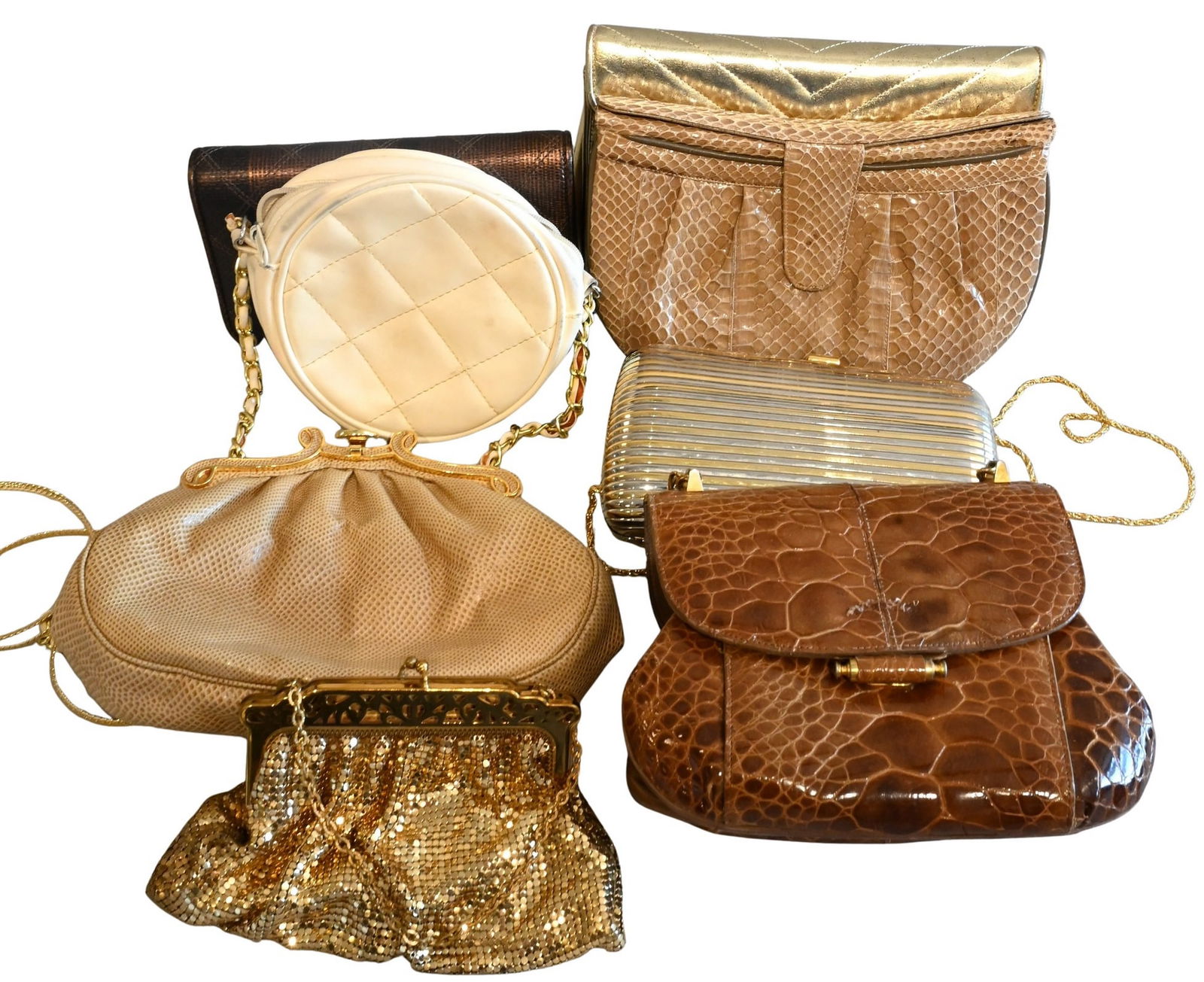Group of Eight Gold and Snakeskin Style Purses: Group of Eight Gold and Snakeskin Style Purses to include Zenith, Jay Herbert, gold metal chain clutch, metal compact clutch, etcetera