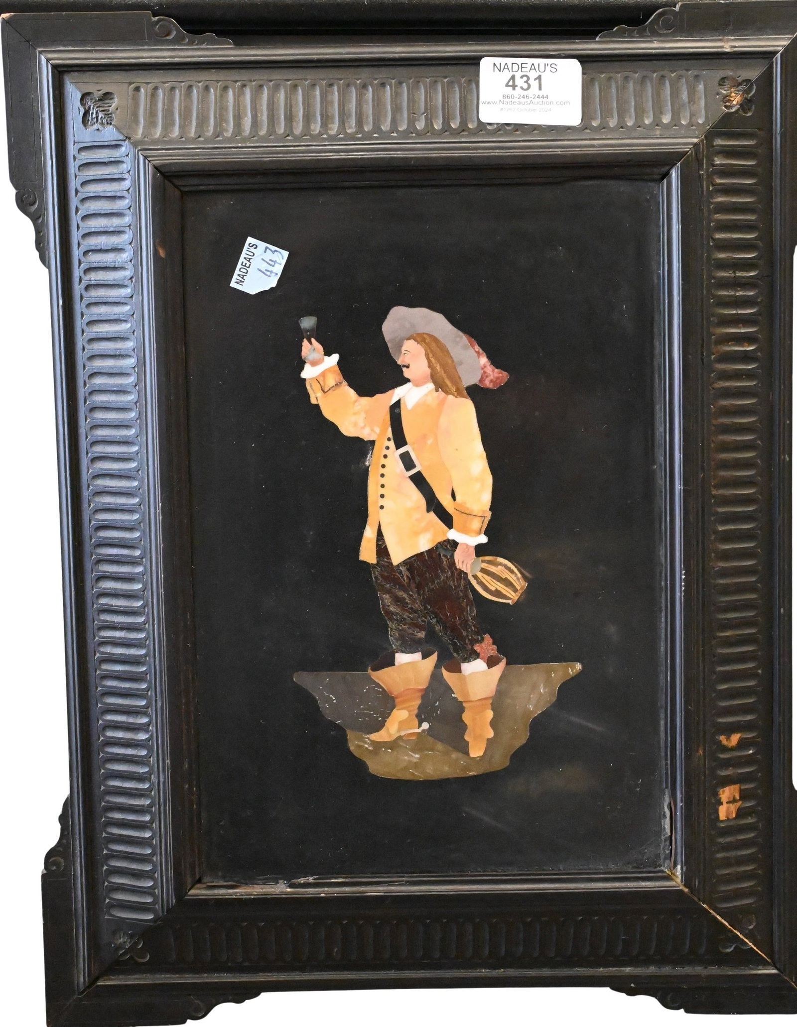 Italian Pietra Dura Plaque: Italian Pietra Dura Plaque depicting a musketeer in a large hat raising up a glass of wine and holding a bottle in his other hand, 19th century in carved ebonized wood frame, frame having some chippin