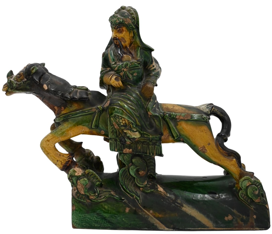 Chinese Ceramic Sancai Roof Tile: Chinese Ceramic Sancai Roof Tile in the form of a warrior on horseback in yellow, black, and green glaze height 15 inches, length 19 inches Condition: age ware, chips and loss throughout, missing horn