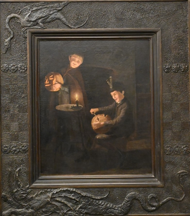 Candlelit Scene of Two Boys Carving Jack-O- Lanterns (1 of 9)