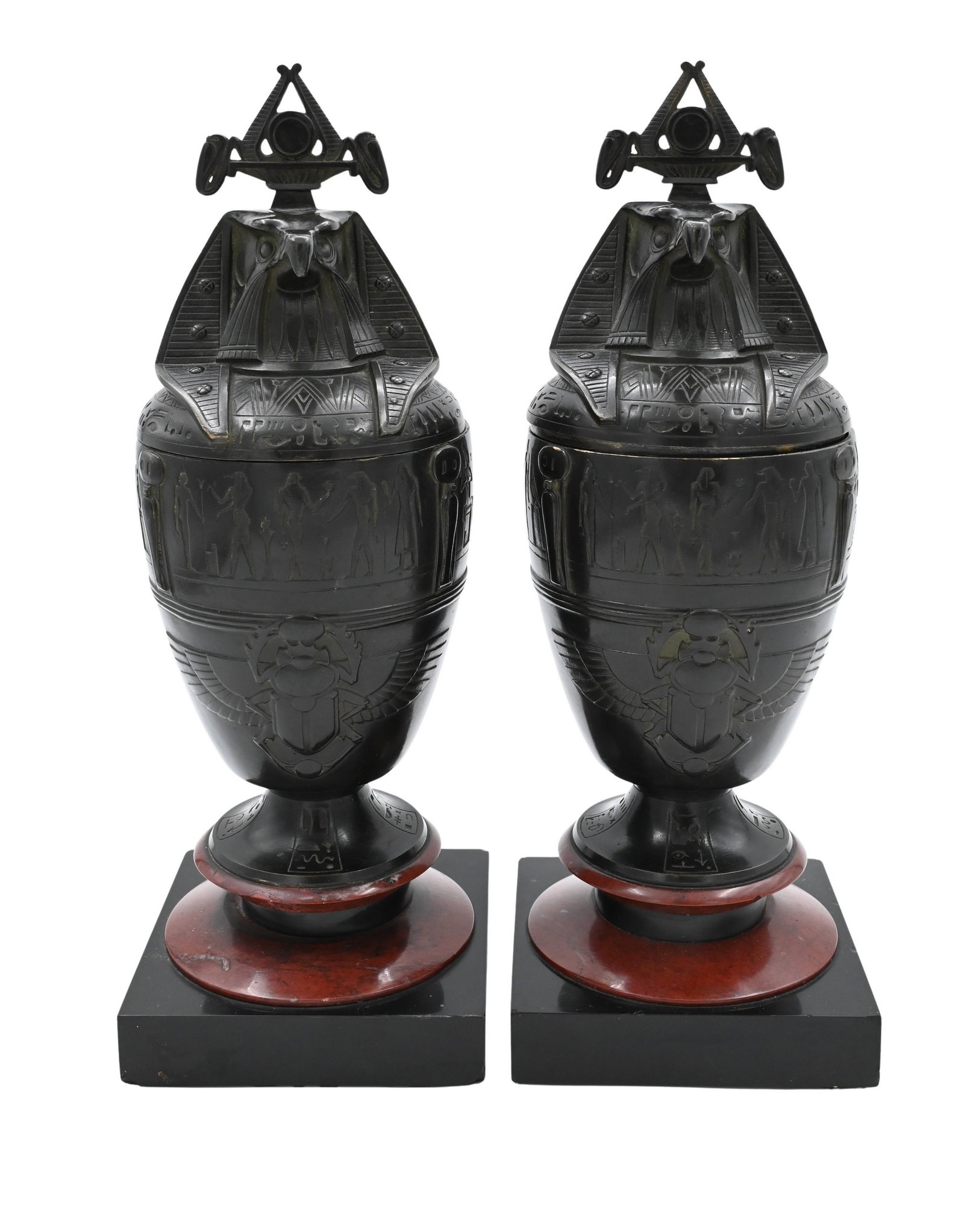 Pair of Egyptian Revival Bronze Covered Urns: Pair of Egyptian Revival Bronze Covered Urns in the form of canopic vases, atop fine black lacquered wood and red marble bases, having falcon's headed effigy of Qebehsenuef Height 12 1/2 inches Proven