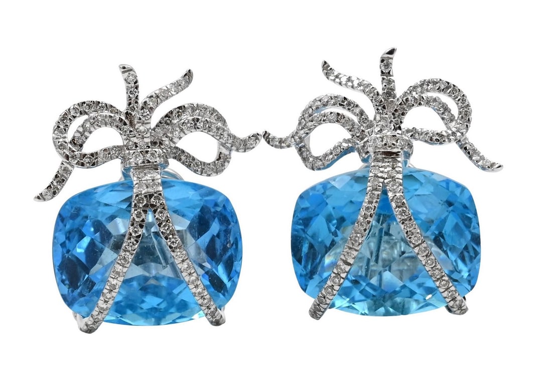 Pair of 18K White, Gold, Blue Topaz, and Diamond Earrings: Pair of 18K White, Gold, Blue Topaz, and Diamond Earrings having large blue topaz (17.5 mm x 13.6 mm), wrapped in a bar with pure set diamonds length 1 inch, total weight 19.6 grams