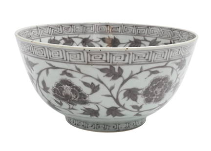 Chinese Ming Style Underglaze Red Porcelain Bowl: Chinese Ming Style Underglaze Red Porcelain Bowl body having slightly flared rim raised on round footed base, handpainted in scrolling vine and flower motif, accented with key fret, remnants of old la