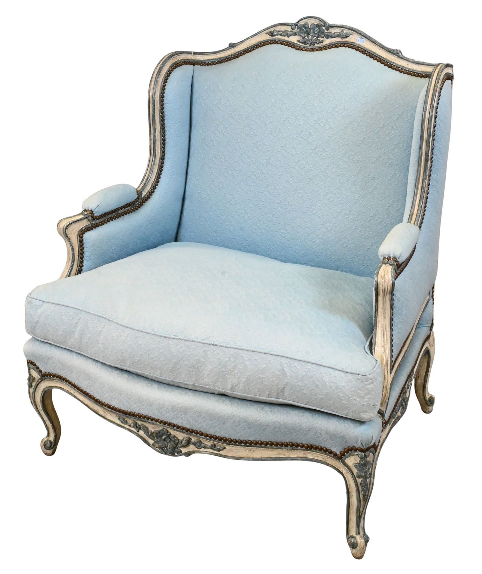 Louis XV Style Painted Bergere: Louis XV Style Painted Bergere having hand carved and grey painted body with nail head and floral accents, in custom blue and down filled cushions, all over cabriole legs height 43 inches, width 36 in