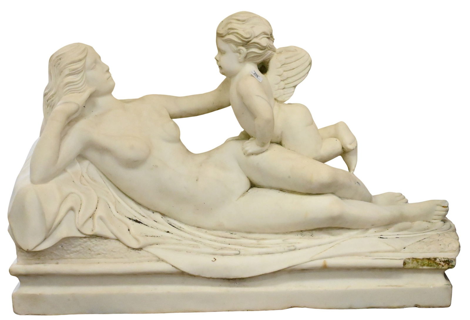 Large Marble Figural Statue of Venus and Cupid: Large Marble Figural Statue of Venus and Cupid featuring the reclining nude goddess reaching out to cupid set on beveled plinth draped with carved fabric height 32 inches, length 45 inches Condition: