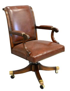 Smith and Watson Style Mahogany and Leather Swivel Desk Chair: Smith and Watson Style Mahogany and Leather Swivel Desk Chair model 111, having carved fluted framework, scrolling arms, nailhead accents, and four feet ending in brass casters Provenance: From a Park