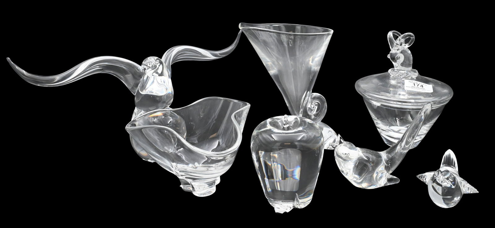 Seven Piece Steuben Crystal Lot: Seven Piece Steuben Crystal Lot to include "Songbird #8112" candy dish having ram head finial #7936, songbird #8603, Apple #7874,a small bird, Trefoil bowl #8123, along with Snail Scroll Form Vase, al