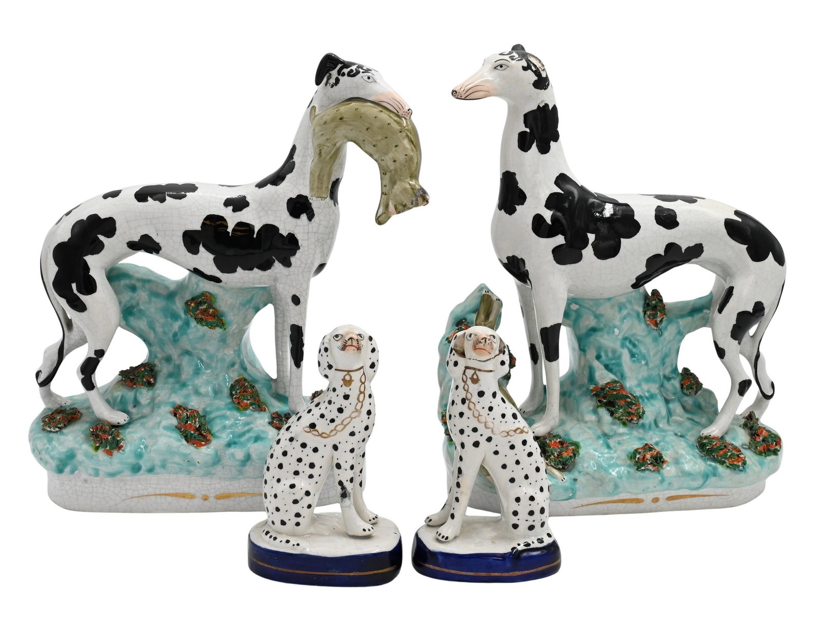 Four Staffordshire Dog Figures: Four Staffordshire Dog Figures to include pair of large Staffordshire hunting greyhounds, black and white dogs one of which is holding a rabbit in its mouth and the other with a rabbit at its feet bot