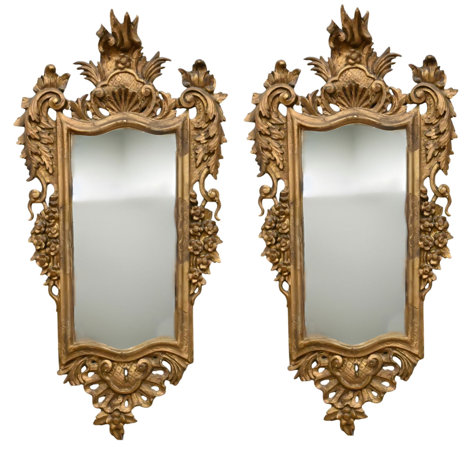 Pair of Italian Carved and Giltwood Mirrors: Pair of Italian Carved and Giltwood Mirrors having carved frame with foliate, floral, and basket-weave motifs, surmounted by a flame crest, original panel back 45" x 24" Provenance: Estate of Nina Sil