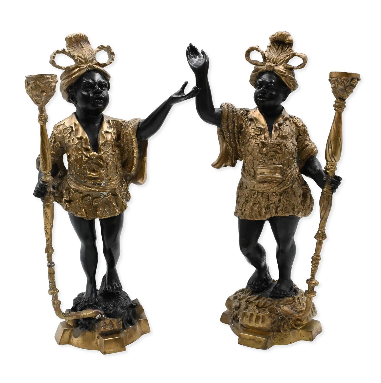 Near Pair of Italian Bronze Blackamoor Figural Torchbearers: Near Pair of Italian Bronze Blackamoor Figural Torchbearers matched pair of cast bronze figural candlesticks, each modeled as a standing youth in ornate feathered headdress and foliate tunic, holding