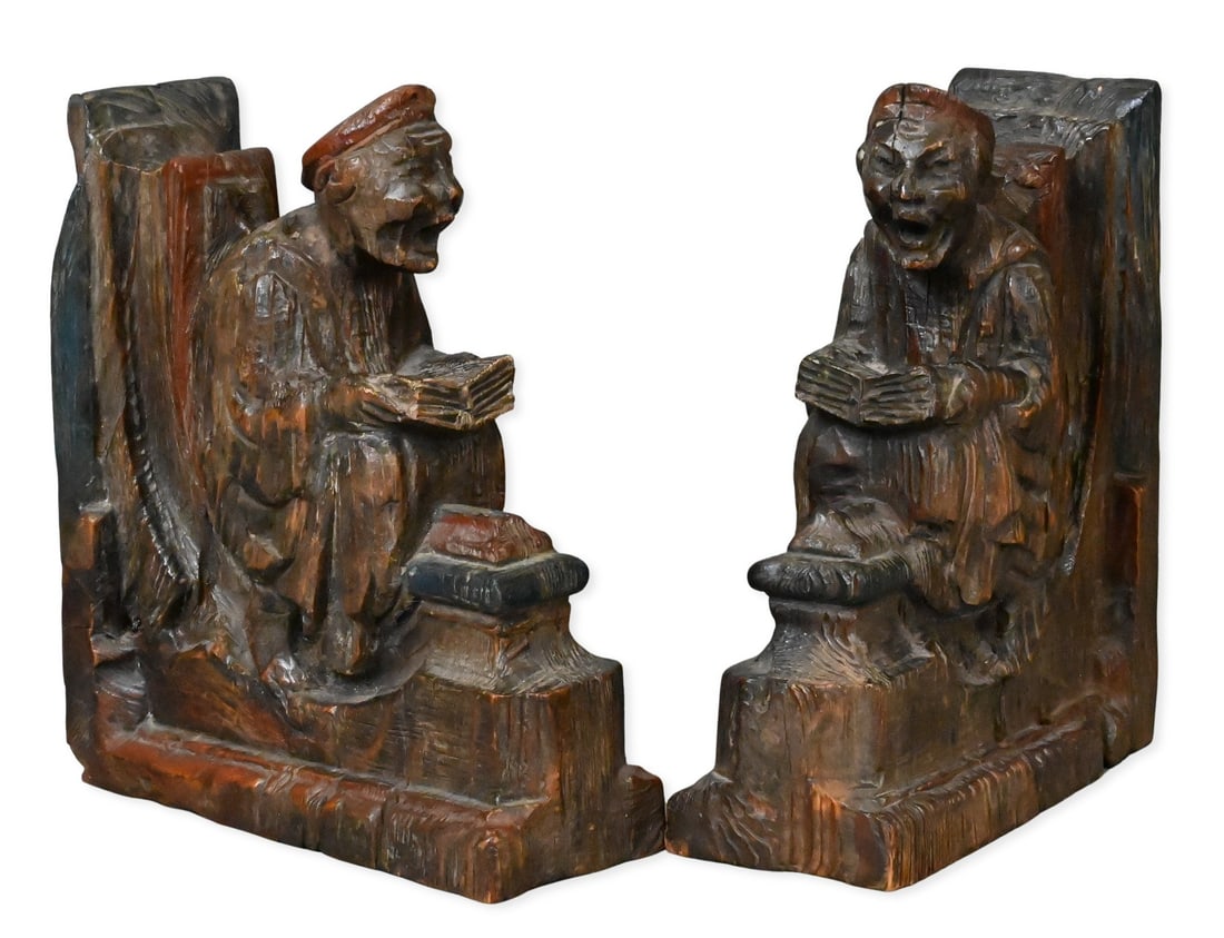 Pair of Polychrome Carved Softwood Scholar Brackets or Bookends: Pair of Polychrome Carved Softwood Scholar Brackets or Bookends probably French, Mid-16th century each carved as a seated scholar reading from an open book, with deeply cut drapery, expressive feature