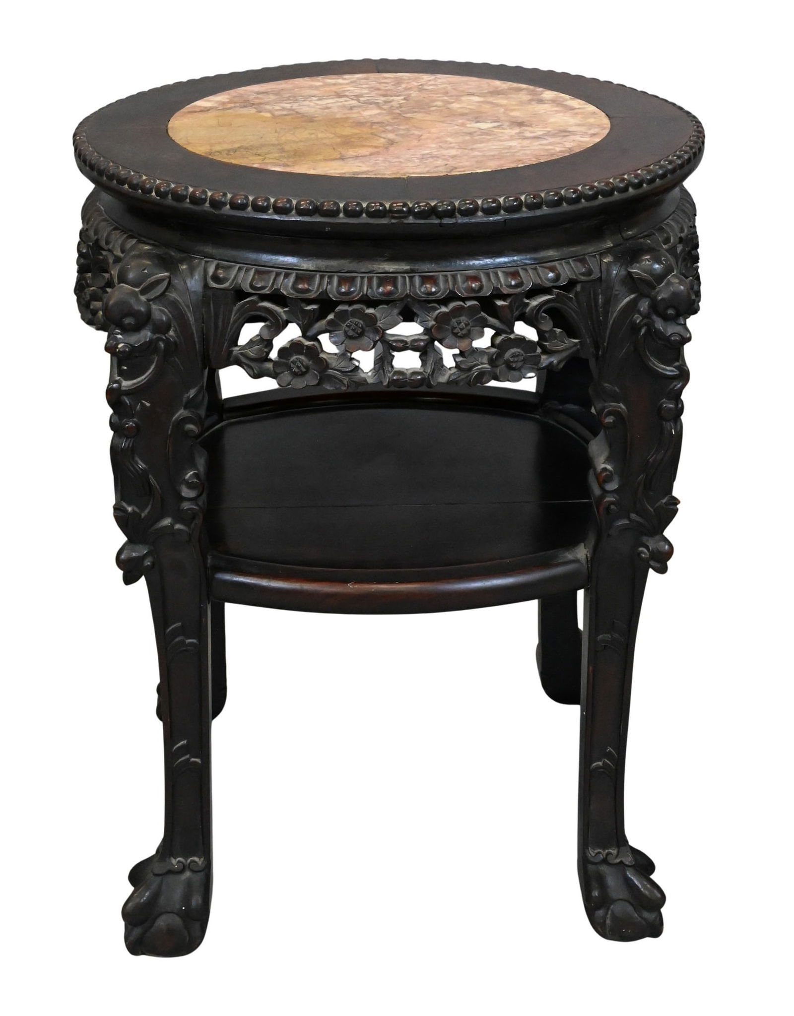 Chinese Carved Hardwood Stand with Marble Inset: Chinese Carved Hardwood Stand with Marble Inset Late 19th / Early 20th Century A circular hardwood stand with marble inset top, the apron deeply carved with floral and foliate designs, raised on four