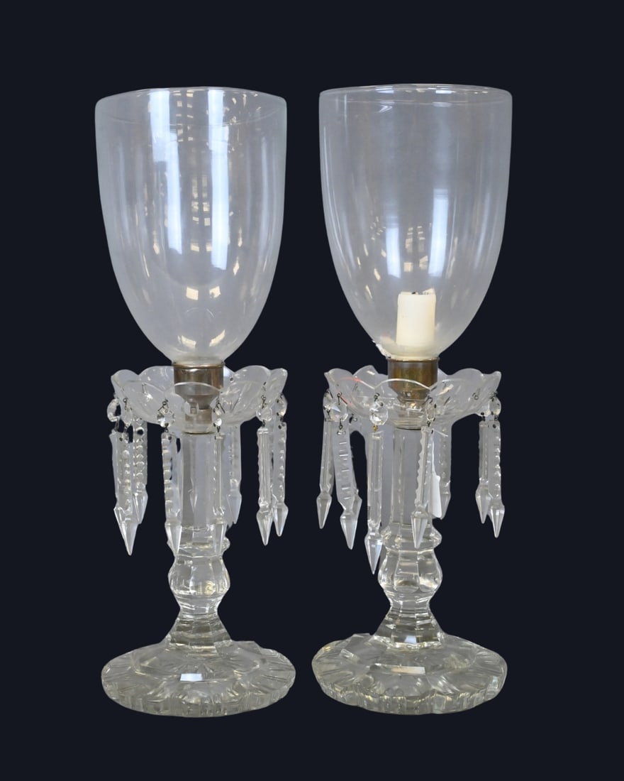 Pair of Cut Glass Mantle Lustres with Hurricane Shades: Pair of Cut Glass Mantle Lustres with Hurricane Shades Each with cut and faceted baluster standard supporting a ring hung with cut glass prisms, surmounted by a tall removable hurricane shade. Raised