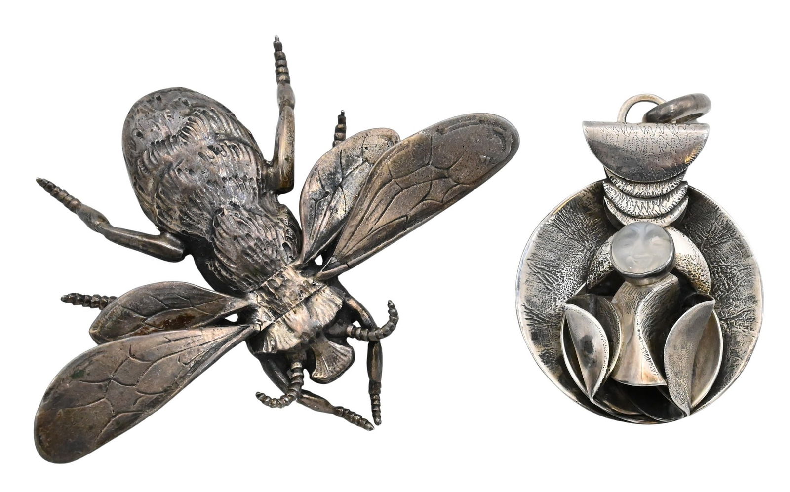 Group of Two Sterling Silver Brooches: Group of Two Sterling Silver Brooches Including a large bee-form brooch marked illegible, Sterling and a modernist pendant with carved moonstone face and stylized foliate surround. Largest 2 inches x