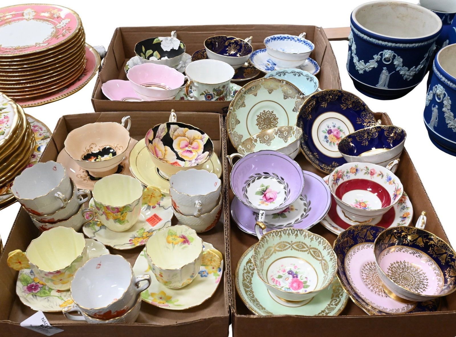 Three Box lots of Paragon Bone China Teacups and Saucers: Three Box lots of Paragon Bone China Teacups and Saucers including assorted floral-decorated patterns. Examples feature hand-painted roses and mixed flowers on black, pale green, turquoise, pink, and